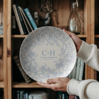 Thumbnail for Personalized wedding plate displayed on a decorative easel in a modern home, showcasing a custom couple name design as a timeless wedding keepsake.