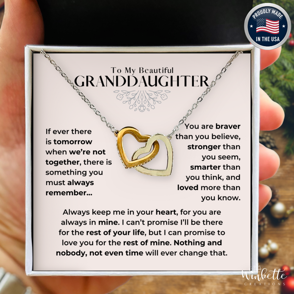 Granddaughter Necklace with two interlocking hearts in a box with a message for a granddaughter, held by a person. Gift from grandma grandpa