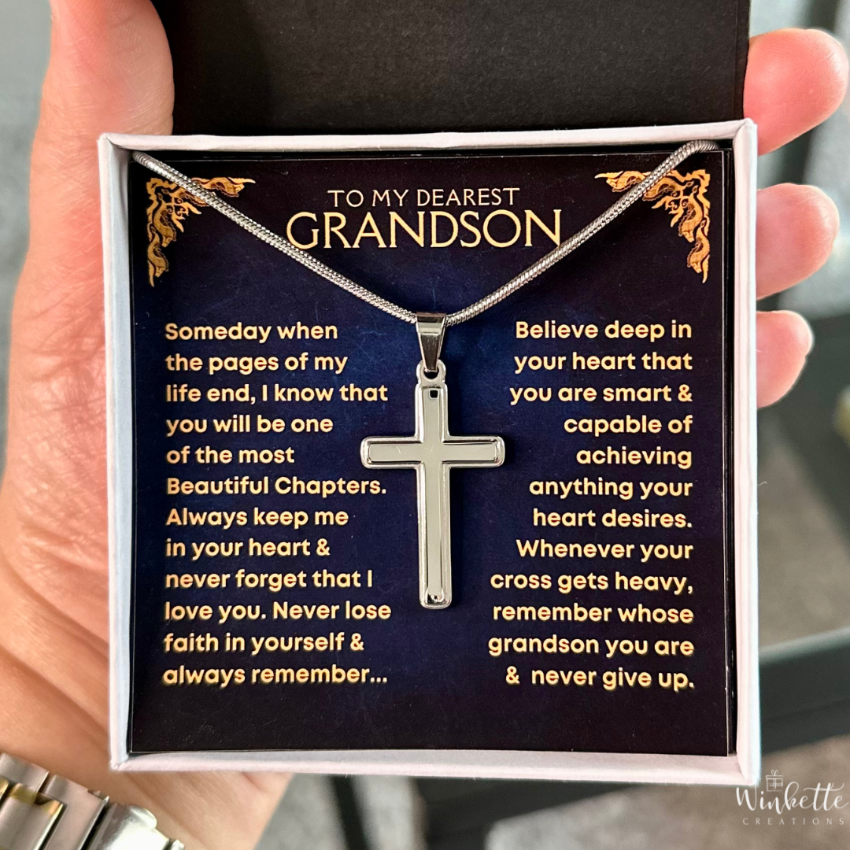 Silver cross necklace with a sentimental message card held by a hand. Gift for grandson from grandma grandpa