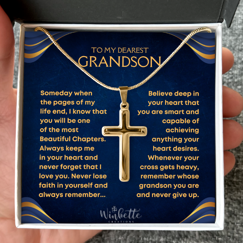 Gold cross necklace in a decorative box with personalized message to a grandson from grandma grandpa