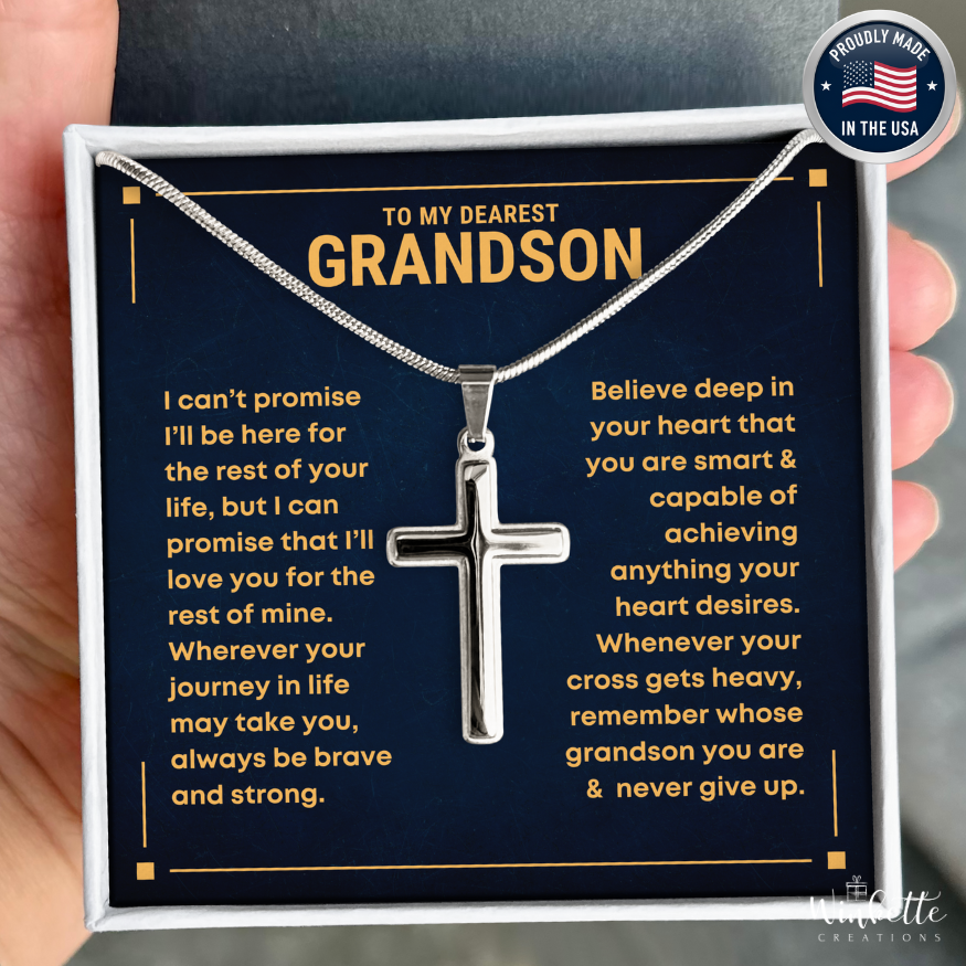 Silver cross necklace with sentimental message card for grandson, held by a hand. Gift from grandma grandma