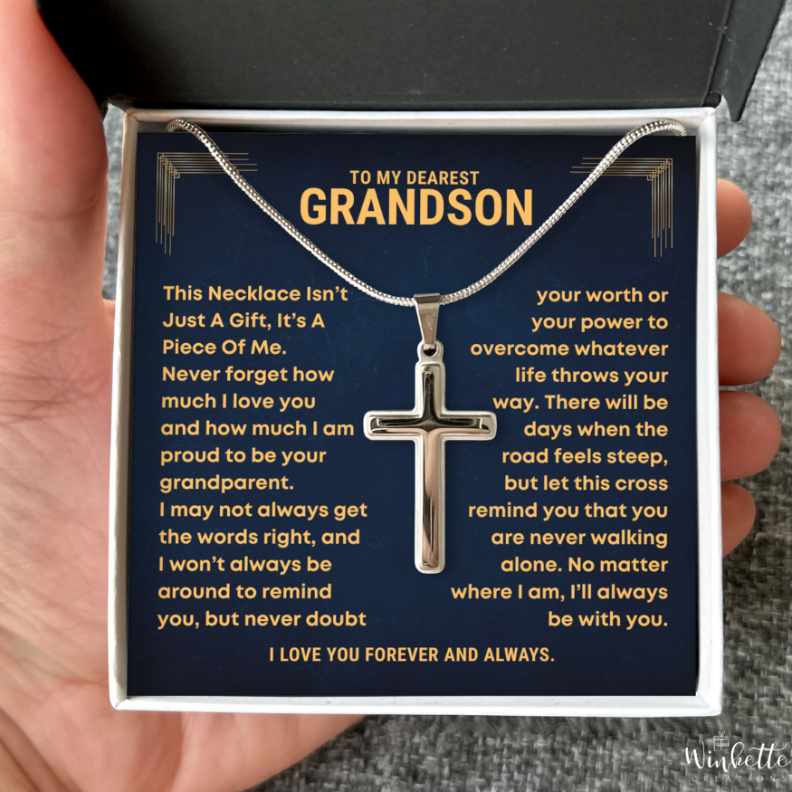 Grandson Necklace with cross pendant in a heartfelt message card held by a hand
