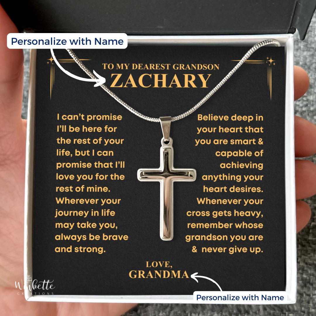 Silver cross necklace on a personalized card held by a hand. Gift for grandson from grandpa grandma