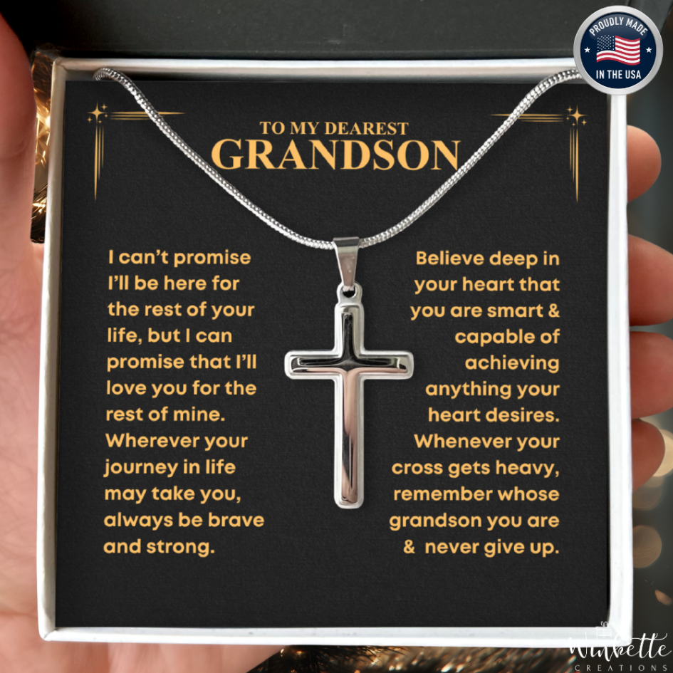 Silver cross necklace with sentimental message card for grandson, held in a hand. gift from grandma grandpa