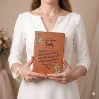 Thumbnail for Personalized leather wedding journal from mom to daughter featuring custom printed message and eucalyptus design, held by a bride in a modern white wedding dress.