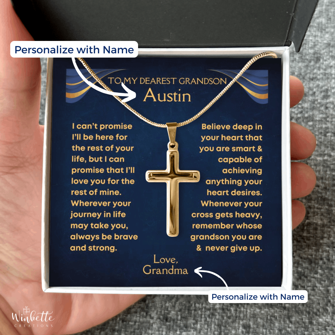 gold cross necklace in a gift box with a personalize message to a grandson, held by a hand. Gift for grandson from grandma grandpa