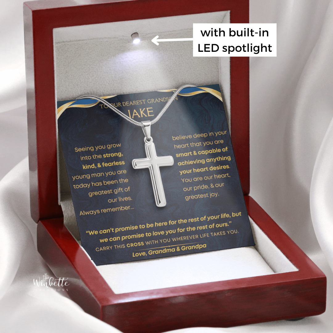 Silver cross necklace in a mahogany box with a built-in LED spotlight
