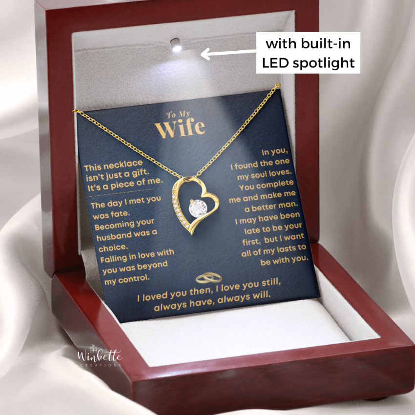 Open burgundy gift box with a gold heart necklace and a “To My Wife” message card, romantic jewelry gift from husband