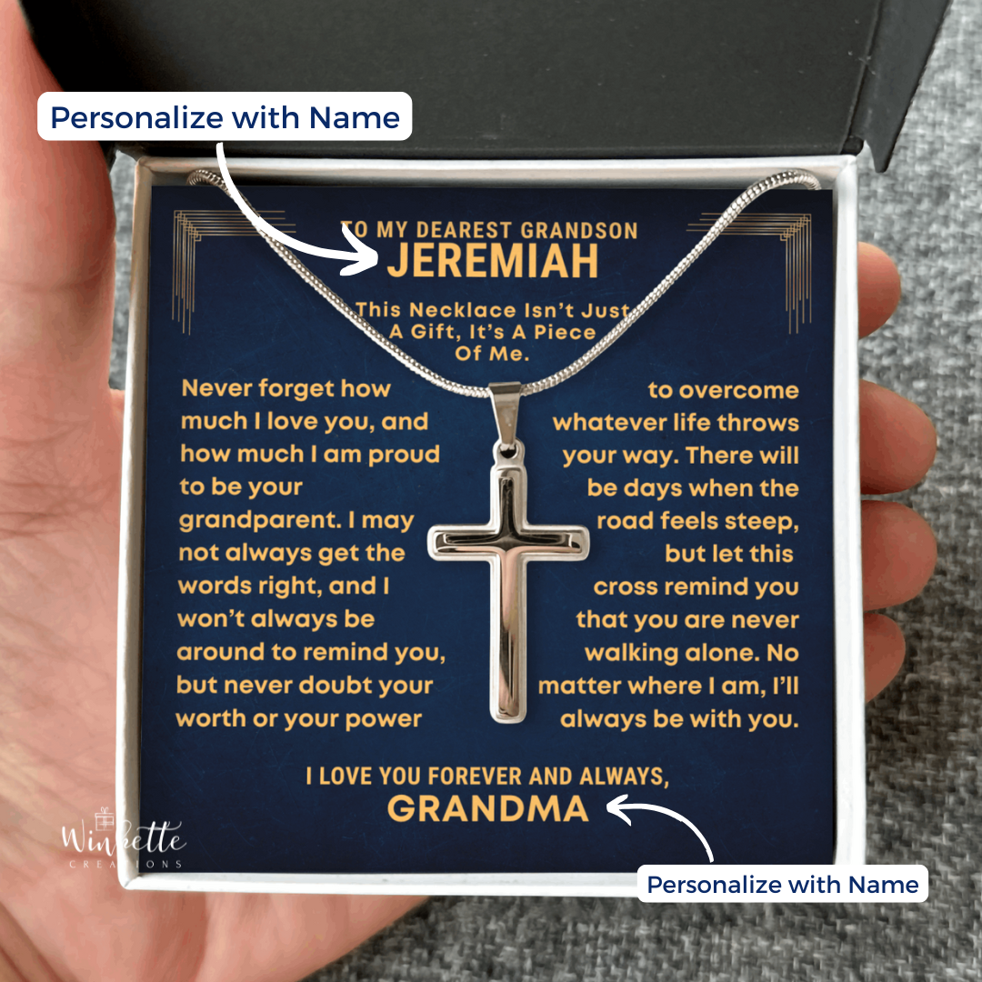 Cross necklace in a gift box with personalized message, held by a hand. gift for grandson from grandfather