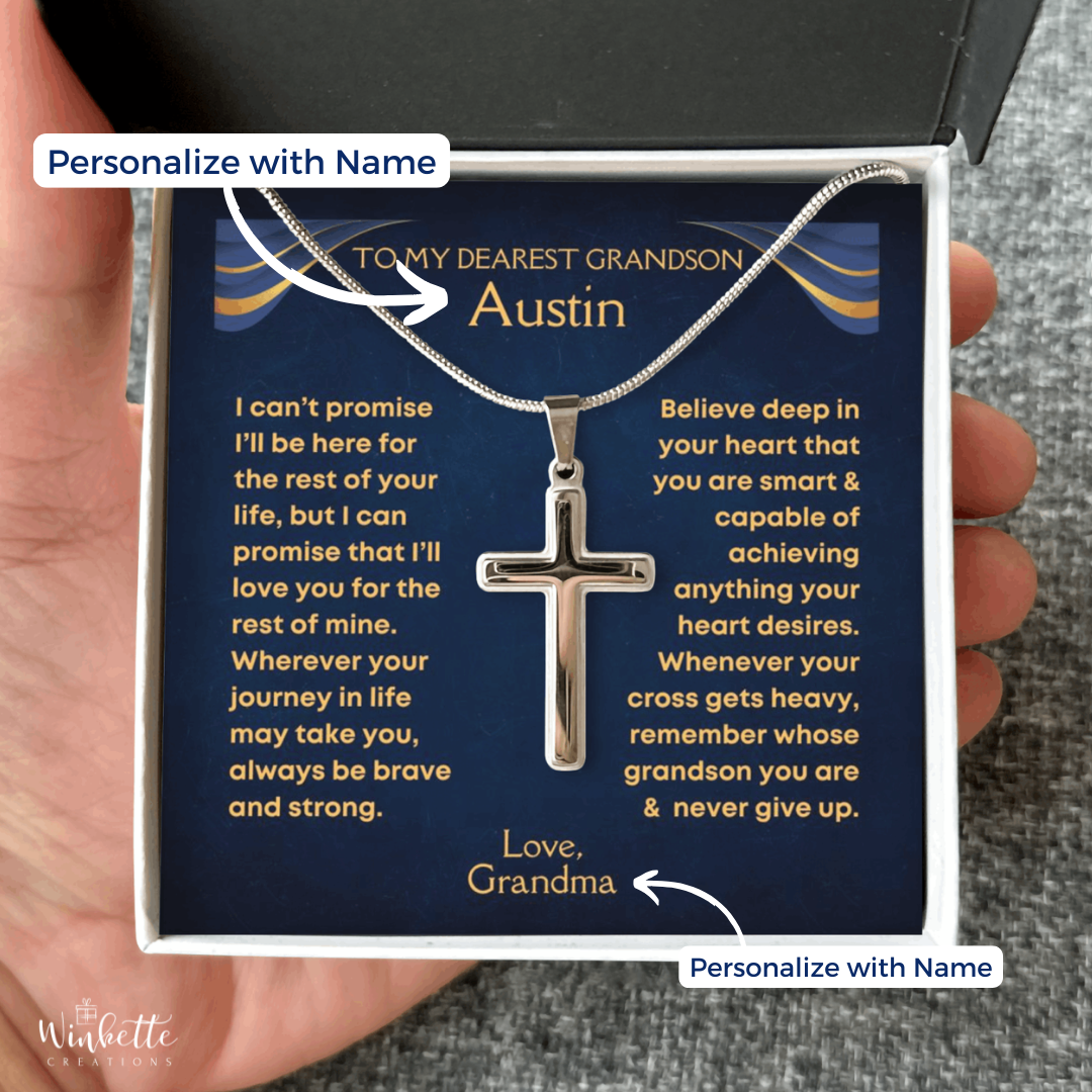 Silver cross necklace in a gift box with a personalized message to a grandson, held by a hand. Gift for grandson from grandma grandpa