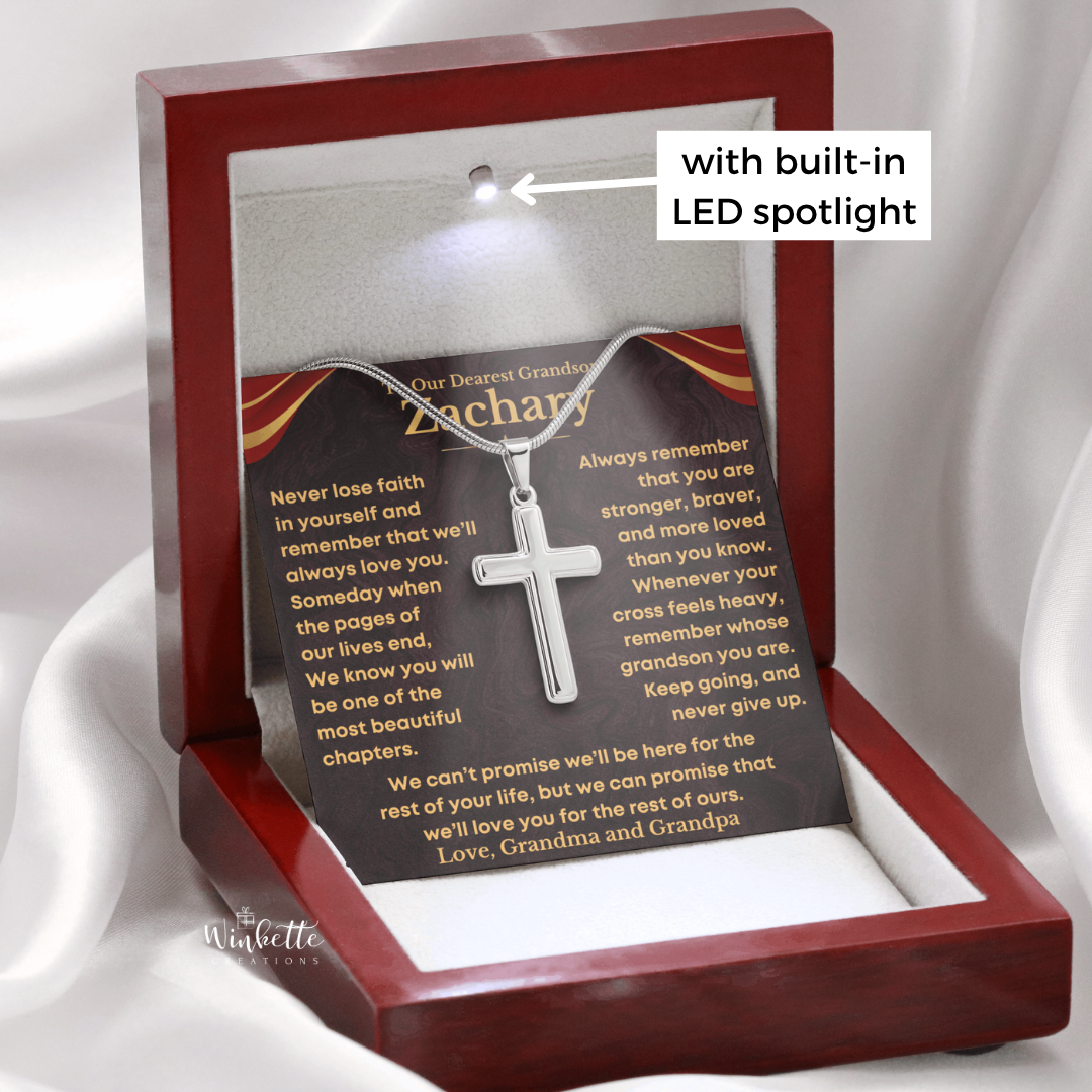 A personalized wooden shadow box gift set with a silver cross pendant and printed remembrance message card, shown with a built-in LED spotlight on a white draped fabric background.