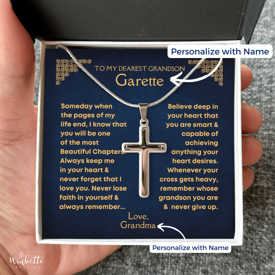 A silver cross necklace on a chain, presented in a gift box with a personalize message card for a grandson.