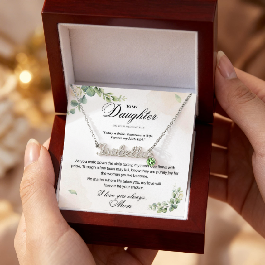 Close-up of a bridal message card for a daughter, displayed with a name necklace in a luxury wooden box.