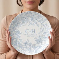 Thumbnail for Woman holding a personalized polymer wedding plate with blue floral artwork, custom couple names, initials, and wedding date to show the plate's size and elegant finish.