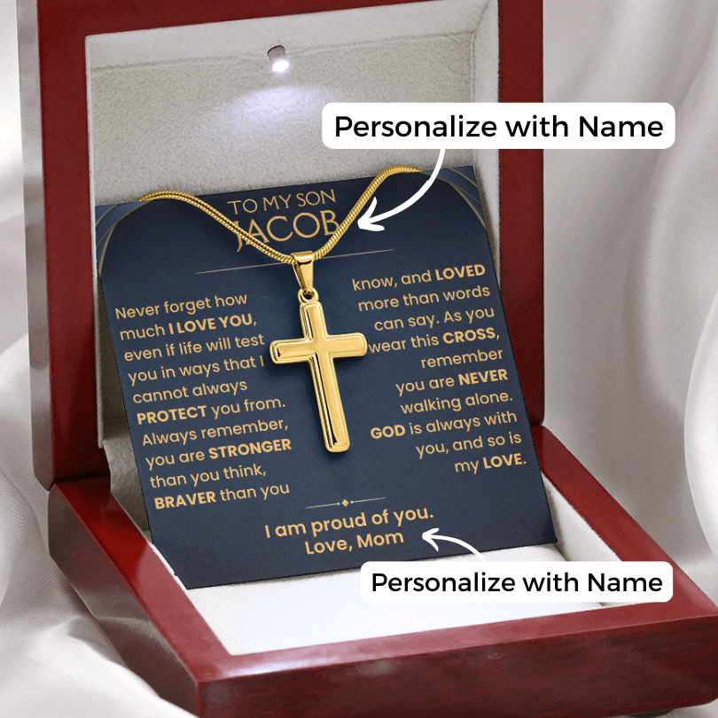 A gold cross pendant necklace displayed inside an open wooden gift box with a personalized message card. The card reads 'TO MY SON JACOB' and includes customizable text areas labeled 'Personalize with Name.