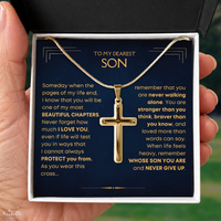 Thumbnail for A gold cross pendant necklace presented in a gift box held by a hand. The necklace is displayed over a dark navy message card addressed 'TO MY DEAREST SON' with a comforting quote printed on the front.
