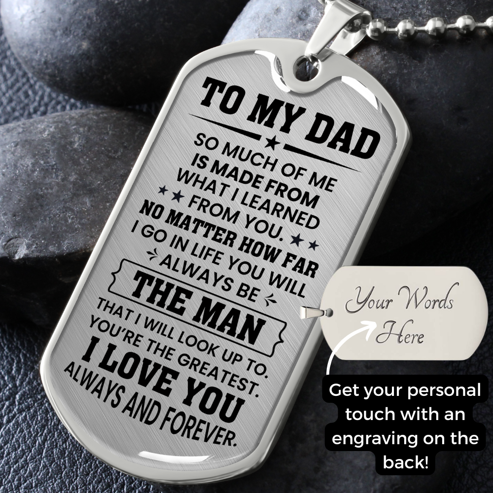 A silver Dog tag necklace with engraved message for dad on a dark stone background. Perfect for father's day gift. 