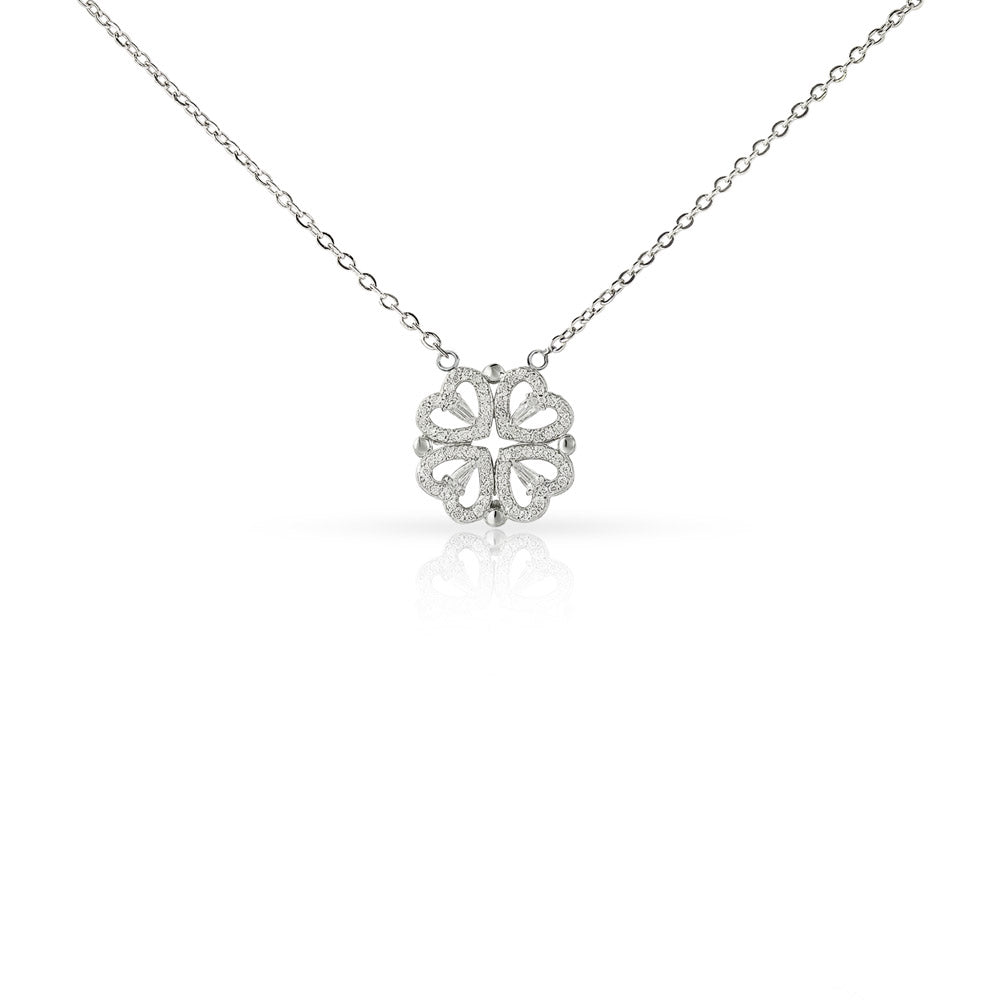 Detailed close-up of a silver four-leaf clover pendant studded with sparkling cubic zirconia crystals on a dainty cable chain.