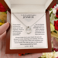 Thumbnail for Necklace with a sentimental personalized message card held by a hand, surrounded by flowers.