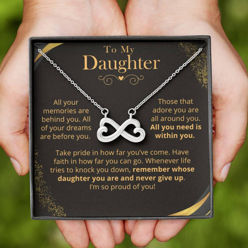 Daughter Necklace with infinity symbol held in hands, displayed on a card with text.