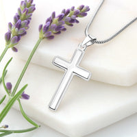 Thumbnail for Silver cross necklace with a chain on a white surface with lavender flowers.