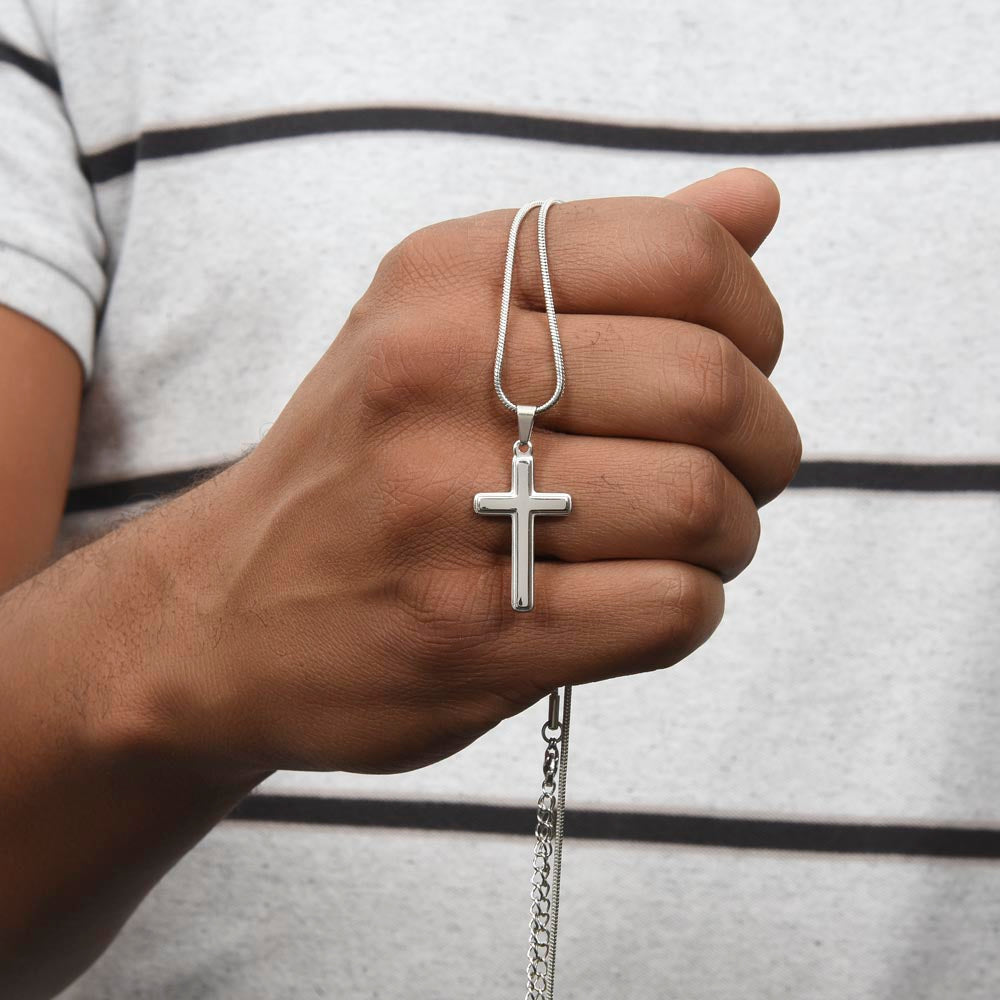 A hand held silver cross necklace for grandson.