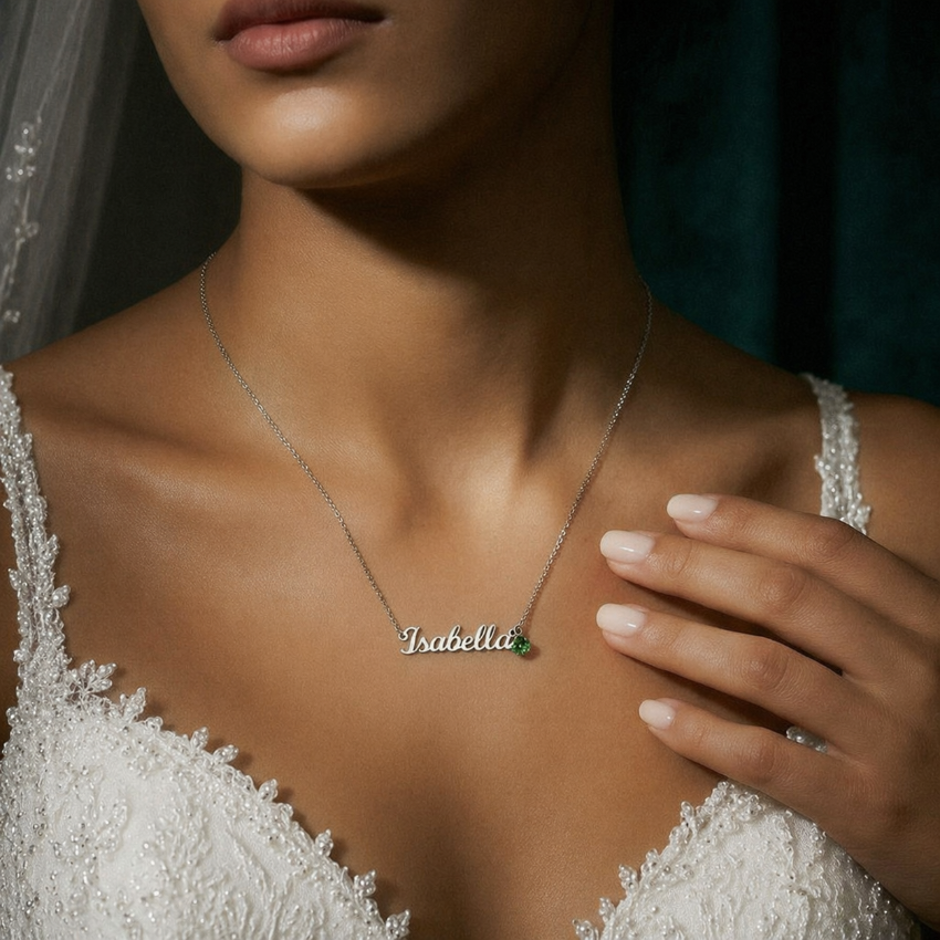 Lifestyle photo personalized silver name necklace with birthstone worn by bride.