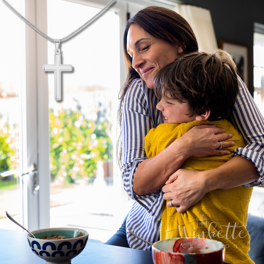 Mom hugging her son in a home setting with a cross necklace visible.