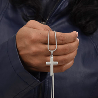 Thumbnail for A hand held silver cross necklace for grandson.
