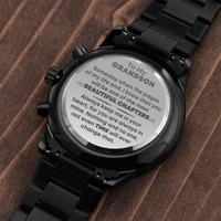 Thumbnail for A black chronograph grandson engraved wristwatch with an engraved heartfelt message for grandson, displayed on a wooden surface. It has a link bracelet and a chronograph function with three dials on the face.